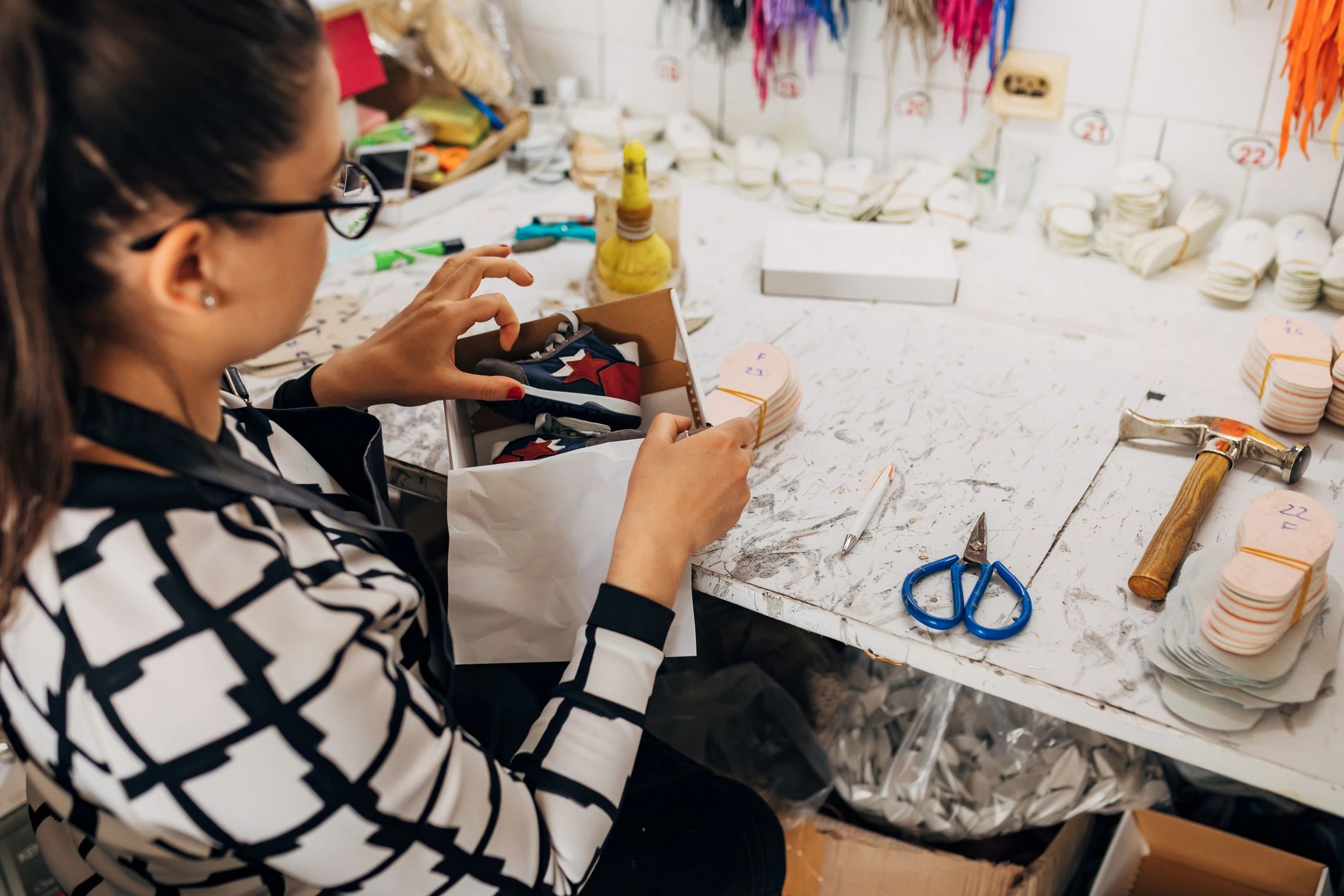 Maker carefully packaging a handmade order